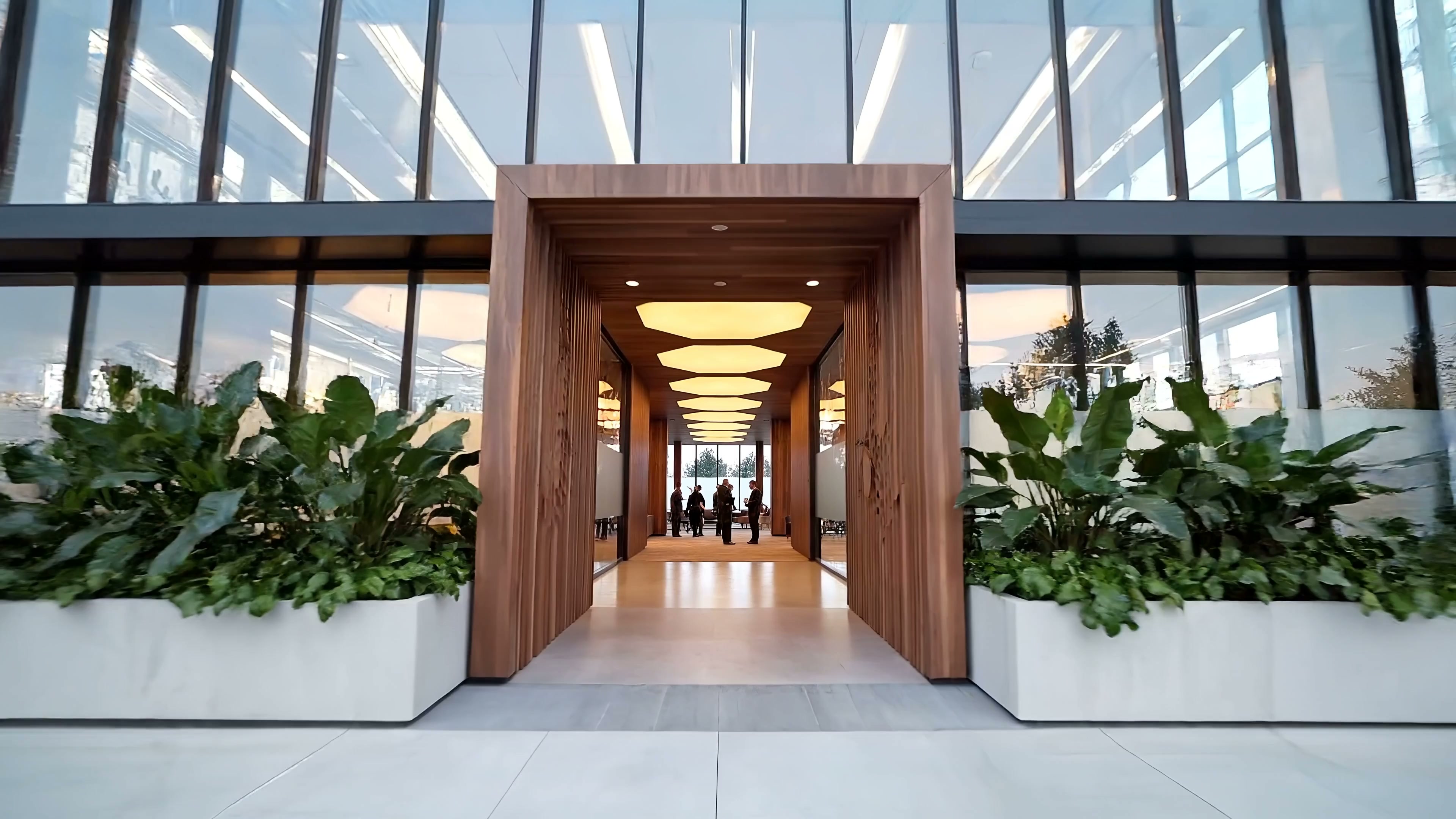 A concept Hive headquarters with warm honeycomb lighting and a gathering in the distant lounge.